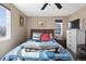 Bedroom featuring a comfortable queen bed, light walls, and a ceiling fan for a cozy atmosphere at 6835 W 55Th Pl, Arvada, CO 80002