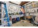 Garage featuring a cluttered workbench, tools, shelving, and storage boxes at 6835 W 55Th Pl, Arvada, CO 80002