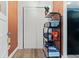 Hallway includes extra storage, wood floors, and orange walls at 6835 W 55Th Pl, Arvada, CO 80002