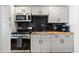 Modern kitchen featuring sleek appliances, dark countertops, and ample cabinet space at 6835 W 55Th Pl, Arvada, CO 80002