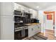 Modern kitchen featuring sleek appliances, dark countertops, and ample cabinet space at 6835 W 55Th Pl, Arvada, CO 80002