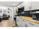Modern kitchen features stainless steel appliances, butcher block countertops and sleek, minimalist cabinetry at 6835 W 55Th Pl, Arvada, CO 80002