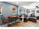 Open concept living area includes wood floors, dining table, comfortable seating, and natural light at 6835 W 55Th Pl, Arvada, CO 80002