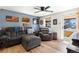 Comfortable living room with modern ceiling fan, wood floors, and an open front door at 6835 W 55Th Pl, Arvada, CO 80002