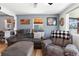 Bright living room featuring comfortable seating, wood floors, and neutral paint at 6835 W 55Th Pl, Arvada, CO 80002