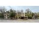 A multi-story apartment complex featuring mature trees and a covered entrance at 1302 S Parker Rd # 316, Denver, CO 80231