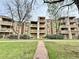 Apartment building with balconies, a pathway and green space at 1302 S Parker Rd # 316, Denver, CO 80231