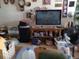 Inviting living room featuring a large tv and decorative items on the walls and shelving at 1302 S Parker Rd # 316, Denver, CO 80231