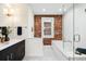 Stylish bathroom featuring exposed brick, a soaking tub and a glass shower enclosure at 1256 N Emerson St, Denver, CO 80218