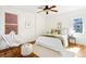 Cozy bedroom featuring hardwood floors, a decorative chair, and a ceiling fan at 1256 N Emerson St, Denver, CO 80218