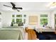 Bright bedroom featuring hardwood floors, multiple windows, and stylish decorative accents at 1256 N Emerson St, Denver, CO 80218