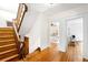 Hallway featuring wood staircase, wood floors and view into bedroom at 1256 N Emerson St, Denver, CO 80218