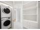A convenient laundry area with a stacked washer and dryer, along with built-in shelving at 1256 N Emerson St, Denver, CO 80218