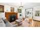 Comfortable living room featuring hardwood floors, a fireplace, and cozy furniture at 1256 N Emerson St, Denver, CO 80218