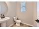 Elegant powder room with pedestal sink and modern fixtures at 9633 Browns Peak Cir, Littleton, CO 80125