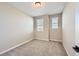 Well-lit bedroom featuring neutral walls and carpet at 9633 Browns Peak Cir, Littleton, CO 80125