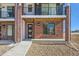 Modern townhome entry with brick facade and balcony at 9633 Browns Peak Cir, Littleton, CO 80125