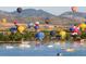 Hot air balloons over a lake with boats and mountains at 9633 Browns Peak Cir, Littleton, CO 80125