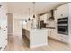 Open concept kitchen with island and white cabinetry at 9633 Browns Peak Cir, Littleton, CO 80125