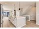 Modern kitchen with island, white cabinets, and stainless steel appliances at 9633 Browns Peak Cir, Littleton, CO 80125