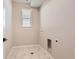 Bright laundry room with tile flooring and window at 9633 Browns Peak Cir, Littleton, CO 80125