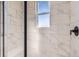 Modern shower with marble-style tile and glass enclosure at 9633 Browns Peak Cir, Littleton, CO 80125