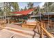 Backyard deck showcasing a hot tub, with a shade structure for outdoor living at 27407 Upper Cold Spg Gulch Rd, Golden, CO 80401