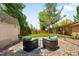 Relaxing backyard seating area with patio, surrounded by gravel and a privacy fence at 3925 Newland St, Wheat Ridge, CO 80033