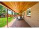 Spacious covered patio with wood ceiling and brick facade offers a great outdoor dining area at 3925 Newland St, Wheat Ridge, CO 80033