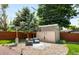 A backyard retreat featuring a storage shed, patio heater, and seating area at 3925 Newland St, Wheat Ridge, CO 80033