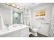 Modern bathroom featuring a stylish vanity, hexagon tile floor, and shower at 3925 Newland St, Wheat Ridge, CO 80033