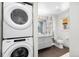 Modern bathroom featuring a stacked washer-dryer and sleek vanity with a mirror at 3925 Newland St, Wheat Ridge, CO 80033