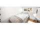 Bright bedroom featuring hardwood floors, natural light, desk and chair, and modern finishes at 3925 Newland St, Wheat Ridge, CO 80033