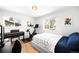 Bedroom featuring hardwood floors, natural light, a stationary bike, and modern finishes at 3925 Newland St, Wheat Ridge, CO 80033