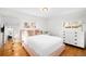 Bright bedroom with hardwood floors, white walls, and a light pink bed frame and side table at 3925 Newland St, Wheat Ridge, CO 80033