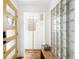 Sunlit foyer with glass block window, modern bench, and sunny yellow door at 3925 Newland St, Wheat Ridge, CO 80033
