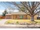 Charming single story home featuring a bright yellow front door and attached one car garage at 3925 Newland St, Wheat Ridge, CO 80033