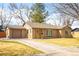 Wide driveway leading to this brick home with a cheerful yellow front door at 3925 Newland St, Wheat Ridge, CO 80033
