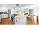 Spacious open-concept kitchen with white cabinets, stainless appliances, and center island at 3925 Newland St, Wheat Ridge, CO 80033