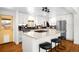 Open concept kitchen with marble countertop island and modern stainless steel appliances at 3925 Newland St, Wheat Ridge, CO 80033