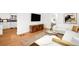 Bright living room featuring hardwood floors, white sectional sofa, and stylish modern decor at 3925 Newland St, Wheat Ridge, CO 80033
