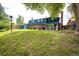 Backyard features a lush lawn, mature trees, a patio, and a storage shed at 4645 W Temple Pl, Denver, CO 80236