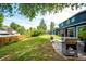 Lush backyard with a privacy fence, mature trees, a shed, and a patio area at 4645 W Temple Pl, Denver, CO 80236