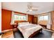 Bright bedroom featuring natural light, wood floors, ceiling fan, and a cozy rug at 4645 W Temple Pl, Denver, CO 80236