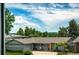 Charming single-story home with a well-manicured lawn, mature trees, and an attached garage at 4645 W Temple Pl, Denver, CO 80236