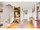 Bright foyer with hardwood floors, staircase, coat closet, and a stylish runner rug at 4645 W Temple Pl, Denver, CO 80236