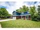 Attractive two-story home with a lush green lawn, two-car garage, and a charming front porch at 4645 W Temple Pl, Denver, CO 80236