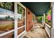 Cozy front porch with rocking chairs and a view of the well-manicured front yard at 4645 W Temple Pl, Denver, CO 80236