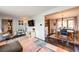 Open-concept living room with view to the dining area and updated flooring at 4645 W Temple Pl, Denver, CO 80236