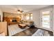 Cozy living room with a brick fireplace, ceiling fan, and a door to the backyard at 4645 W Temple Pl, Denver, CO 80236